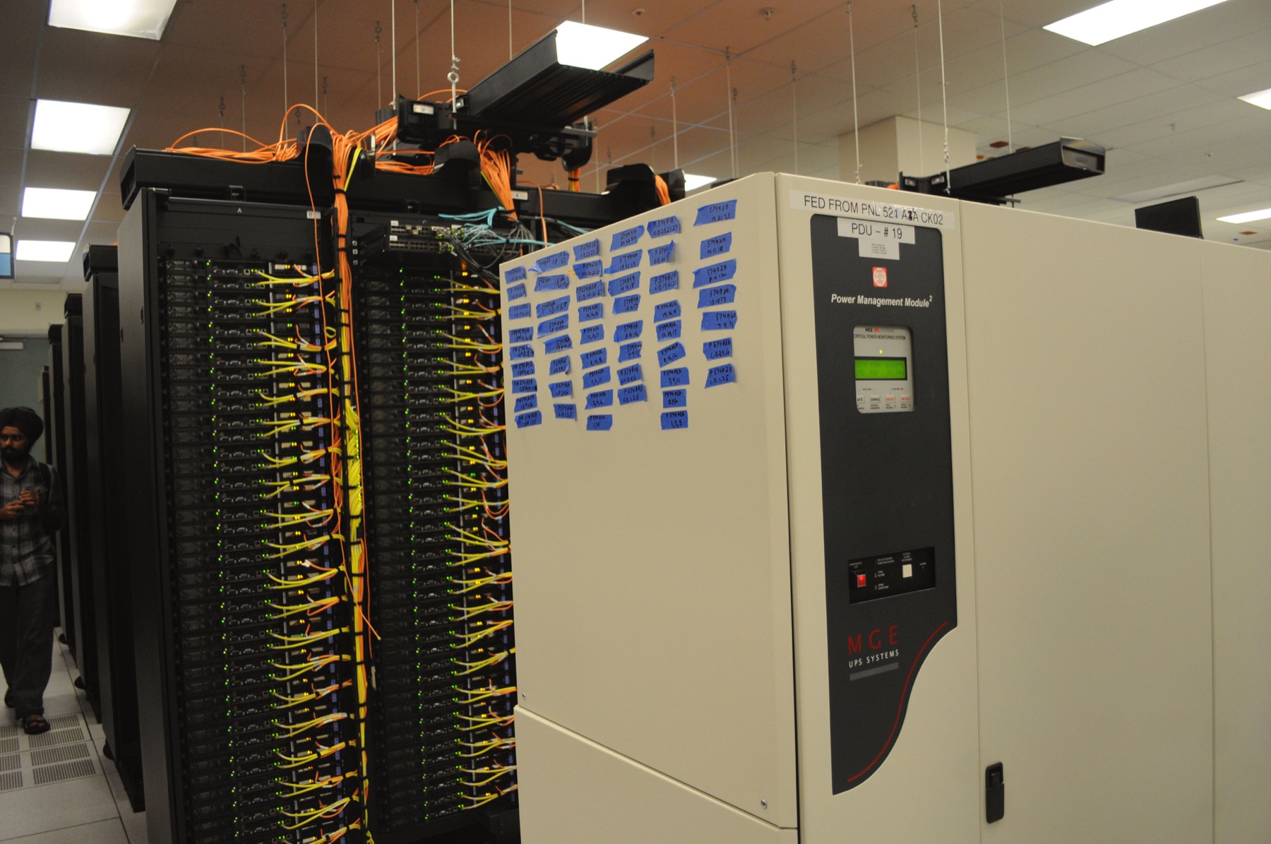 Data center racks with power management equipment and network cabling
